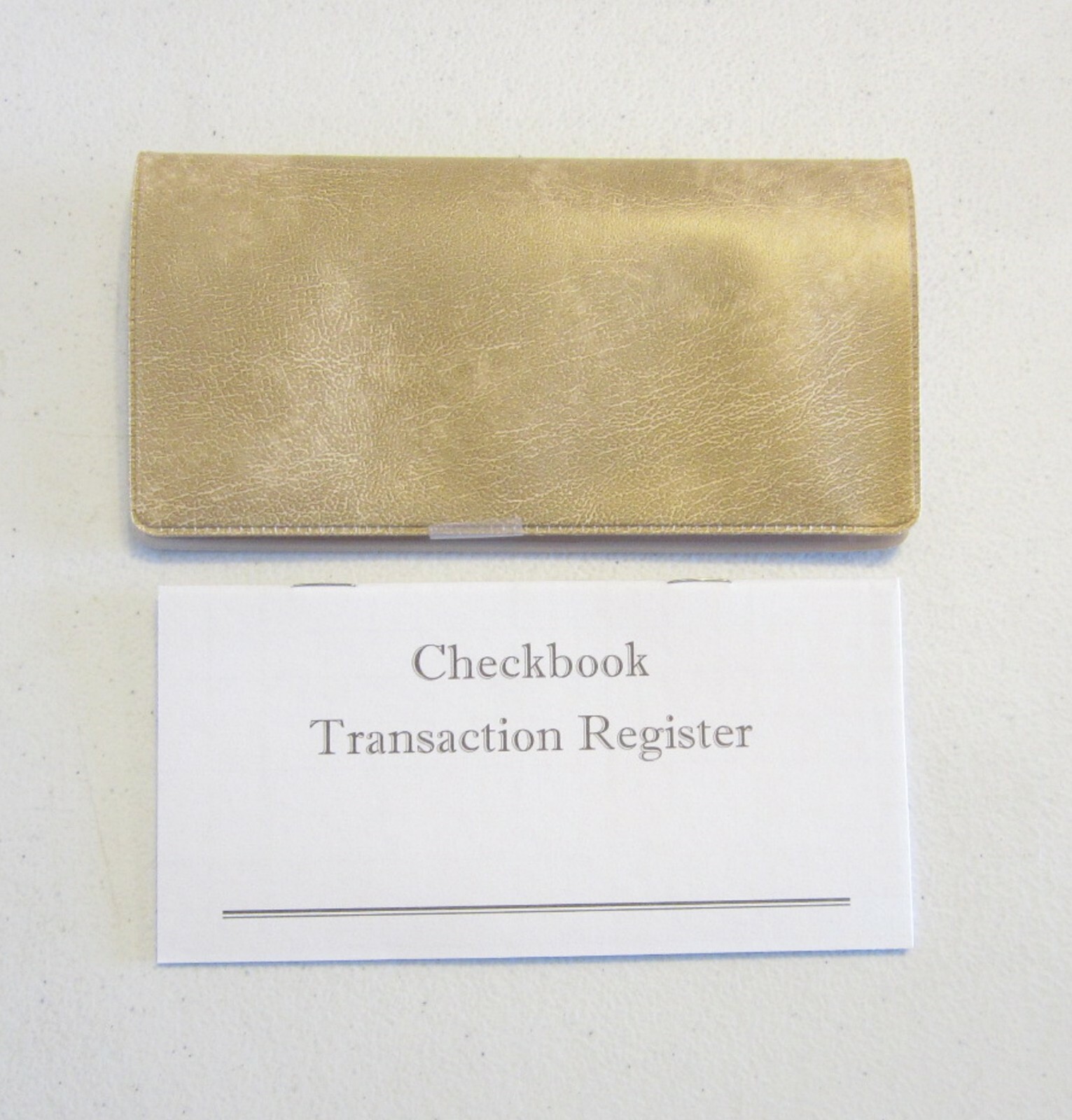 1 WHITE PARCHMENT VINYL CHECK BOOK COVER & 6 CHECKBOOK TRANSACTION REGISTERS