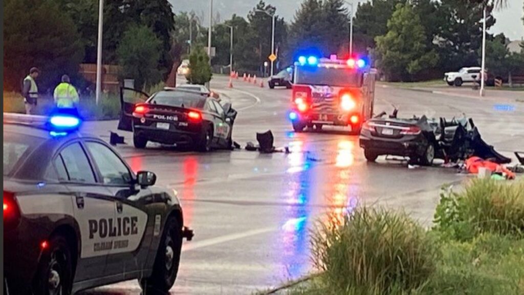 A photo of a police vehicle coming to a car accident scene.