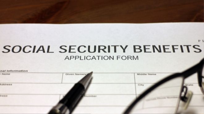 A social security disability benefits application on a table. A social security disability benefits application on a table.